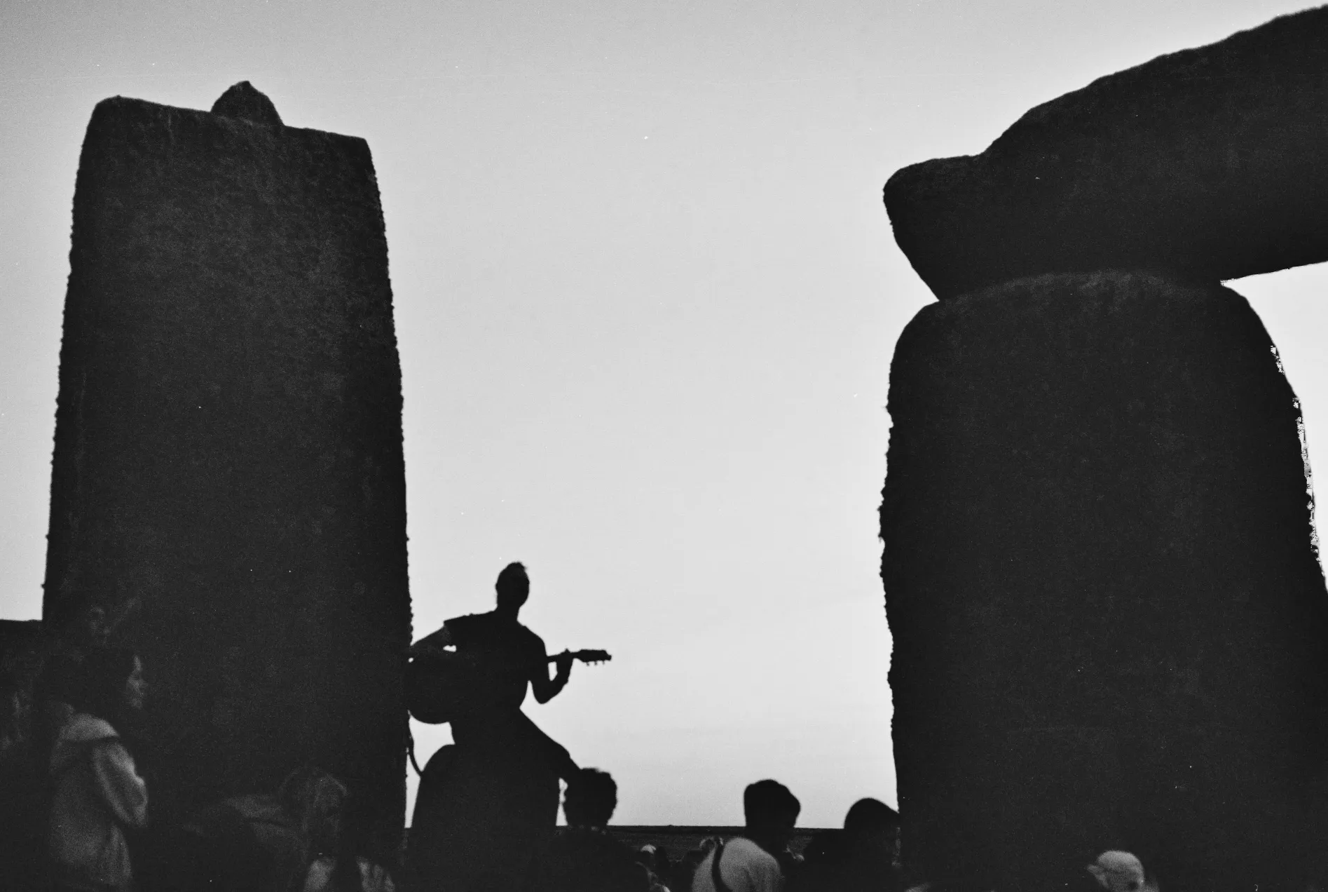 person playing guitar on a hengestone