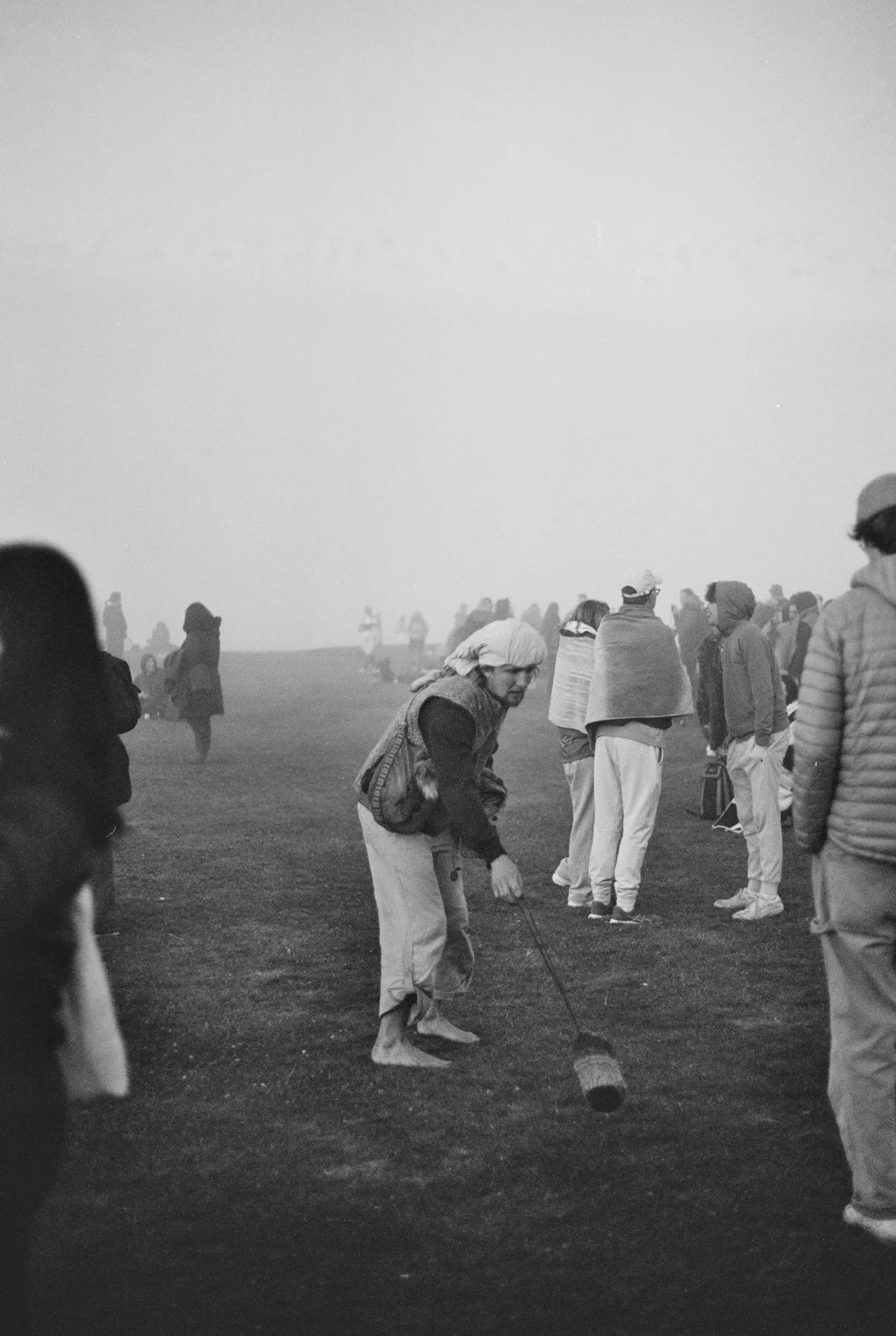 traditionally dressed person spreading smoke