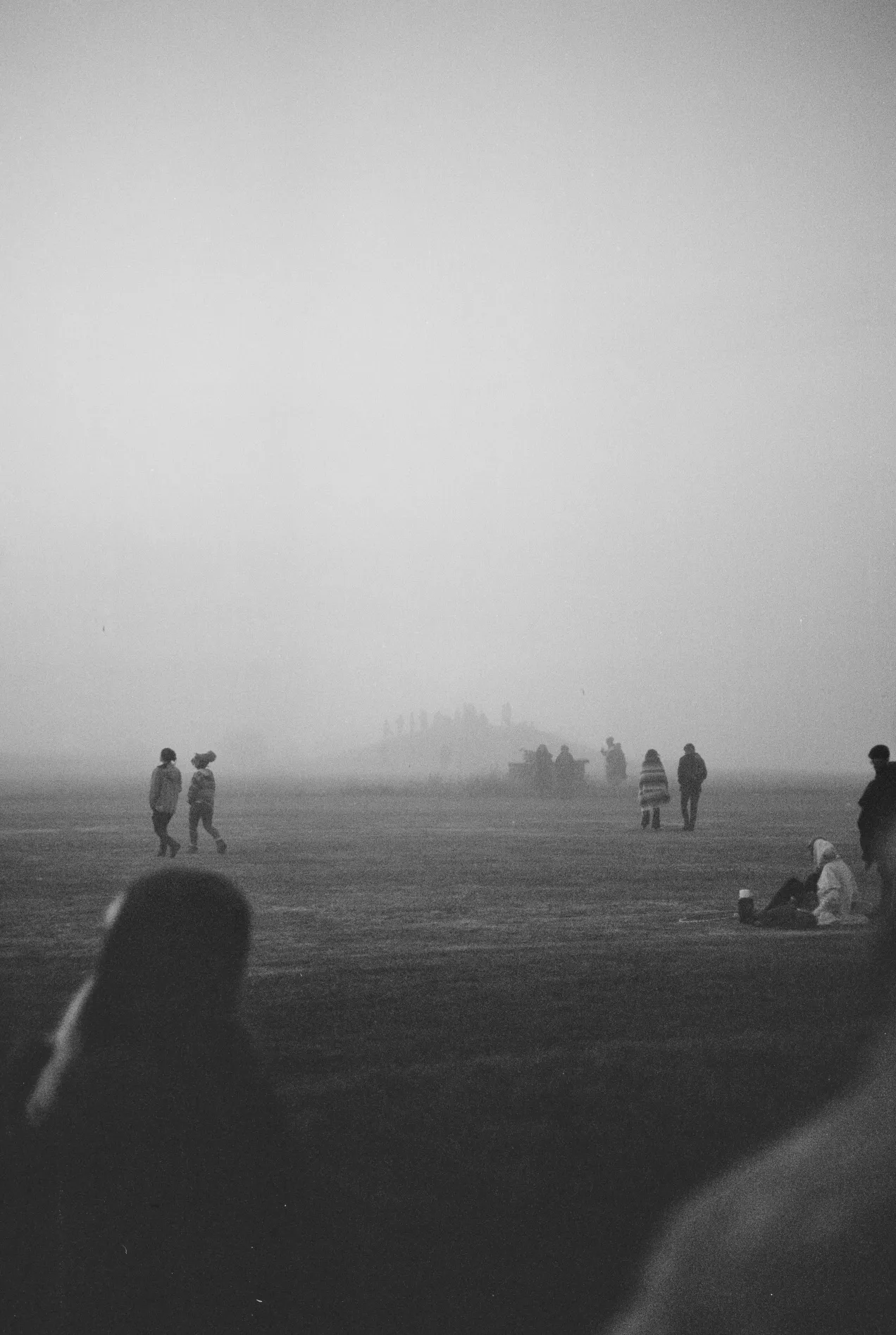 distant foggy people on the hill